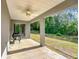 Covered back porch area provides a view of the lush backyard, perfect for relaxing or entertaining at 9525 Sw 200 Ct, Dunnellon, FL 34431