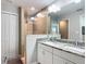 Elegant bathroom featuring double vanity, granite countertops and a tiled shower with glass enclosure at 9525 Sw 200 Ct, Dunnellon, FL 34431