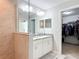 Bathroom with granite countertops, a tiled shower with a glass partition, and access to a walk-in closet at 9525 Sw 200 Ct, Dunnellon, FL 34431