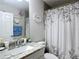Bathroom featuring granite countertops, neutral walls and floral shower curtain and decor at 9525 Sw 200 Ct, Dunnellon, FL 34431