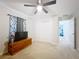 Neutral bedroom features a closet, window with curtains and wood dresser for comfortable living at 9525 Sw 200 Ct, Dunnellon, FL 34431