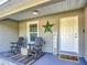Cozy front porch featuring inviting seating, decorative touches, and a charming welcome mat at 9525 Sw 200 Ct, Dunnellon, FL 34431