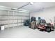 Spacious two car garage with lawn care equipment and two dogs in kennels at 9525 Sw 200 Ct, Dunnellon, FL 34431