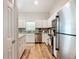 A modern kitchen is showcased with stainless steel appliances and white cabinets at 9525 Sw 200 Ct, Dunnellon, FL 34431