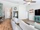 Bright and airy living room with an open floor plan, featuring wood floors and neutral decor at 9525 Sw 200 Ct, Dunnellon, FL 34431