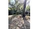 Spacious backyard with mature trees creating a serene ambiance and landscape views at 9711 Sw 196Th Cir, Dunnellon, FL 34432