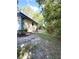 View of the home's exterior and spacious backyard surrounded by lush trees and natural landscape at 9711 Sw 196Th Cir, Dunnellon, FL 34432