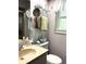 Cozy bathroom featuring neutral walls, vanity with sink, toilet and decor at 9711 Sw 196Th Cir, Dunnellon, FL 34432