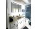 Bathroom featuring tile floor, double sink vanity, framed mirror and shower at 9711 Sw 196Th Cir, Dunnellon, FL 34432