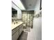 Well-lit bathroom featuring a vanity, toilet and shower with floral pattern at 9711 Sw 196Th Cir, Dunnellon, FL 34432