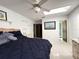 Bright bedroom with blue bedding, adjacent bathroom, fan, and unique shelving at 9711 Sw 196Th Cir, Dunnellon, FL 34432