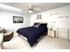 Bedroom features a comfortable bed with blue bedding, ceiling fan, and accent furniture at 9711 Sw 196Th Cir, Dunnellon, FL 34432