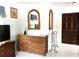 Bedroom featuring a rattan dresser with glass top and decorative mirror, adjacent to a closet at 9711 Sw 196Th Cir, Dunnellon, FL 34432