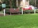 Inviting bench with manicured green lawn and hedges in front of building at 9711 Sw 196Th Cir, Dunnellon, FL 34432