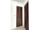 View of two closets with wood-paneled doors and neutral carpet at 9711 Sw 196Th Cir, Dunnellon, FL 34432