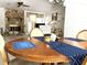 Open floor plan shows dining area leading to a living room with a stone fireplace at 9711 Sw 196Th Cir, Dunnellon, FL 34432