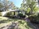 Landscaped home exterior featuring lush green grass and well-maintained shrubs at 9711 Sw 196Th Cir, Dunnellon, FL 34432