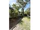 Side view of home with lush landscaping and mature trees offering shade at 9711 Sw 196Th Cir, Dunnellon, FL 34432