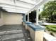 Covered porch area with decorative columns and ample space for seating at 9711 Sw 196Th Cir, Dunnellon, FL 34432