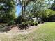 A manicured front yard with ornamental trees and shrubs enhancing the curb appeal at 9711 Sw 196Th Cir, Dunnellon, FL 34432