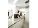 Kitchen with light countertops and appliances looking into the adjacent living room at 9711 Sw 196Th Cir, Dunnellon, FL 34432