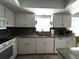 White kitchen with clean appliances and updated countertops at 9711 Sw 196Th Cir, Dunnellon, FL 34432