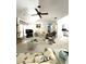 Bright living room featuring vaulted ceilings, fireplace, and cozy seating area at 9711 Sw 196Th Cir, Dunnellon, FL 34432