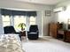 Cozy main bedroom with sitting area, large windows and relaxing atmosphere at 9711 Sw 196Th Cir, Dunnellon, FL 34432