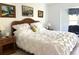 Bright main bedroom featuring a comfortable bed, natural light and tasteful decor at 9711 Sw 196Th Cir, Dunnellon, FL 34432