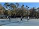 Pickle ball courts with mature trees, lighting, and a variety of people playing at 9711 Sw 196Th Cir, Dunnellon, FL 34432
