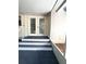 A cozy front porch with steps leading to a set of double doors, offering a welcoming entry at 9711 Sw 196Th Cir, Dunnellon, FL 34432