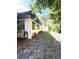 The exterior shows the side of the home with tidy landscaping and a fenced area at 9711 Sw 196Th Cir, Dunnellon, FL 34432