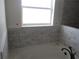 Elegant bathroom with a soaking tub and subway tile surround at 10409 Sw 45 St, Ocala, FL 34481