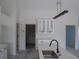 Bright kitchen featuring white cabinets, a center island sink, and modern lighting at 10409 Sw 45 St, Ocala, FL 34481