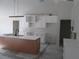 Modern kitchen with a center island, white cabinets, and a sleek faucet at 10409 Sw 45 St, Ocala, FL 34481