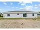 This backyard has new grass growing and sliding glass doors for access to the home at 10426 Sw 133Rd Ave, Dunnellon, FL 34434