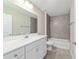 This bathroom features tile floors and tub/shower, plus white sink and vanity at 10426 Sw 133Rd Ave, Dunnellon, FL 34434