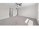 Large main bedroom with neutral carpeting, abundant natural light, and ample closet space in a comfortable design at 10426 Sw 133Rd Ave, Dunnellon, FL 34434