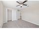This bedroom features neutral walls, ceiling fan, closet and carpeted floors at 10426 Sw 133Rd Ave, Dunnellon, FL 34434