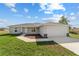 Charming single-story home features a well-manicured lawn, neutral siding, and an attached two-car garage at 10426 Sw 133Rd Ave, Dunnellon, FL 34434