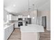 Beautiful kitchen with white cabinets, stainless steel appliances, a center island with bar seating, and modern lighting at 10426 Sw 133Rd Ave, Dunnellon, FL 34434