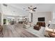 Spacious living room featuring hardwood floors, neutral paint, and an open floor plan to the kitchen and dining area at 10426 Sw 133Rd Ave, Dunnellon, FL 34434