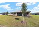 Lush backyard featuring a well-kept lawn, a charming house, and thoughtfully placed trees for scenic beauty at 10530 Sw 98Th Pl, Ocala, FL 34481