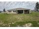 Spacious backyard featuring a covered patio and lush green lawn at 10530 Sw 98Th Pl, Ocala, FL 34481