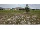 Expansive backyard featuring a covered patio and freshly planted shrubbery at 10530 Sw 98Th Pl, Ocala, FL 34481