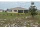 Large backyard showcasing new landscaping with a covered porch at 10530 Sw 98Th Pl, Ocala, FL 34481
