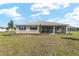 Beautifully landscaped backyard with lush green grass, a single-story home, and mature trees at 10530 Sw 98Th Pl, Ocala, FL 34481