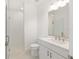 Bathroom with white vanity and shower featuring frameless glass doors and white subway tile at 10530 Sw 98Th Pl, Ocala, FL 34481