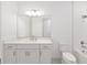 Bright bathroom featuring white cabinets, modern fixtures, and a shower with white subway tile at 10530 Sw 98Th Pl, Ocala, FL 34481