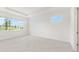 Bright bedroom featuring natural light from three windows and neutral tile flooring at 10530 Sw 98Th Pl, Ocala, FL 34481